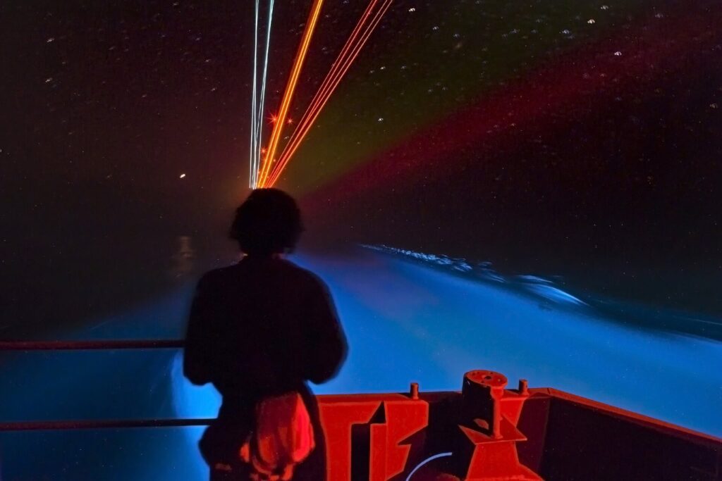 Man enjoying Grand Cayman’s incredible bioluminescence off boat
